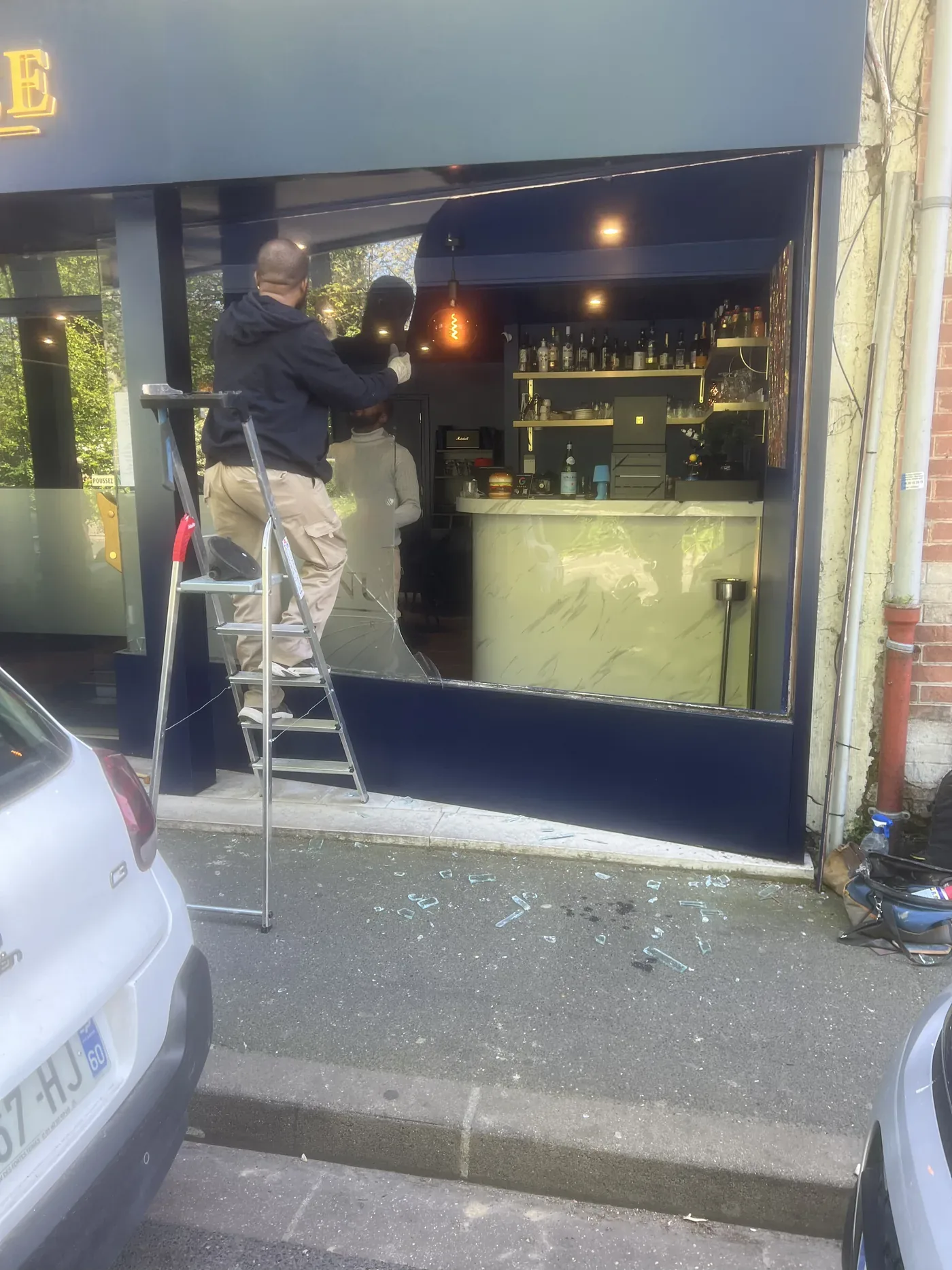Remplacement de la vitrine d'un bar en cours d'intervention
